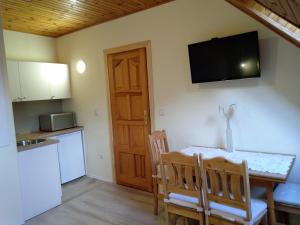 a kitchen and dining room with a table and chairs at Muszla in Pobierowo