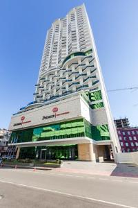 a large building with a store in front of it at Апартамент с видом на море in Batumi