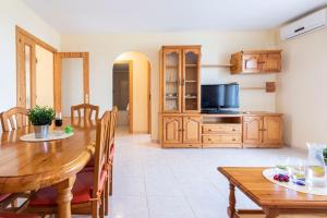 uma cozinha e sala de jantar com uma mesa e uma televisão em Homes & Go Mare Internum I em La Pineda
