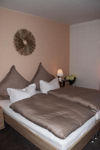 a bedroom with a large bed and a mirror on the wall at Hotel- Restaurant Kerzan´s in Dortmund