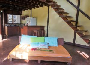 a room with a kitchen with a table and a staircase at Yellow Houses Bocas DUPLEX in Bocas del Toro