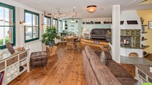 a living room with a couch and a table at Hotel Garni Nussbaumhof in Ueckeritz