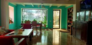 a living room with green walls and a table at Four Seasons in Kutaisi in Kutaisi