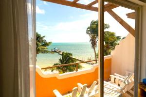 a room with a view of the beach and the ocean at Seaside Villas in Caye Caulker