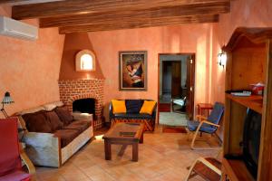 a living room with a couch and a fireplace at Loma de Guadalupe Alamos Sonora in Álamos