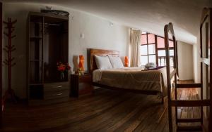 Un pat sau paturi într-o cameră la Askha Cusco