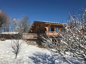 a log cabin in the snow with snow covered trees at Chalet Cyclamens- 65m2 plein centre des Carroz - WIFI & parking! in Les Carroz d'Araches