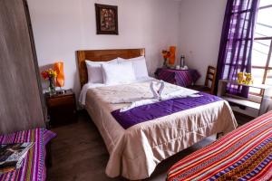 Un pat sau paturi într-o cameră la Askha Cusco