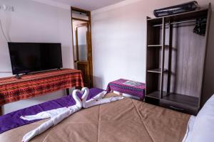 Un pat sau paturi într-o cameră la Askha Cusco