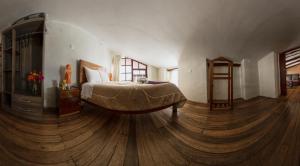 Un pat sau paturi într-o cameră la Askha Cusco