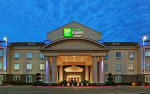 a hotel with a sign on the front of a building at Holiday Inn Express Hotel & Suites Kilgore North by IHG in Kilgore