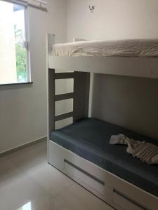 a bedroom with two bunk beds and a window at Lençóis Ville Residence - CHALE 22 in Barreirinhas
