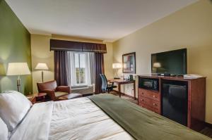 a hotel room with a bed and a flat screen tv at Holiday Inn Express & Suites Wytheville, an IHG Hotel in Wytheville