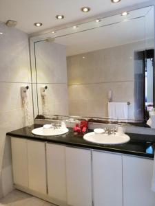 a bathroom with two sinks and a large mirror at Boutique Hotel Palacio in Santo Domingo