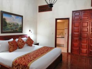 a bedroom with a large bed and a bathroom at Boutique Hotel Palacio in Santo Domingo +46 photos