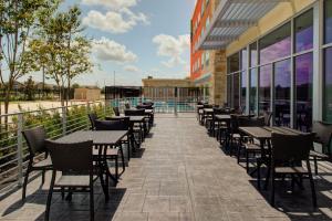 a row of tables and chairs outside of a building at Holiday Inn Express & Suites - Houston NW - Cypress Grand Pky, an IHG Hotel in Cypress