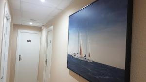 a large picture hanging on a wall in a hallway at Hostal El Altet in El Alted