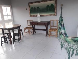 a dining room with a table and chairs at Hotel Village Toritama in Toritama