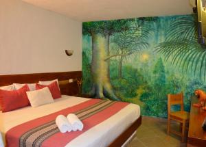 Кровать или кровати в номере Axkan Arte Hotel Tuxtla