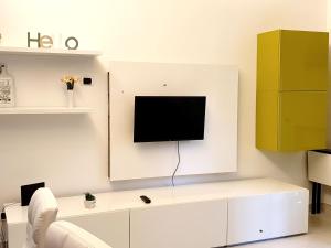 a living room with a tv on a wall at appartamento Ostia a due passi dal mare in Lido di Ostia
