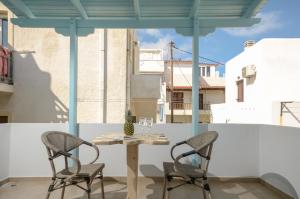 a table and two chairs on a balcony at Pension Irene 1 in Naxos Chora