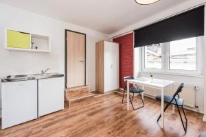 a kitchen with a table and chairs in a room at Pension Michelangelo in Eisenach