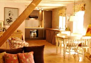 a kitchen and living room with a table and chairs at Chateau Igny in La Perche