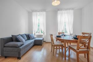 a living room with a couch and a table at CITYSTAY Plac Walowy Gdansk in Gdańsk