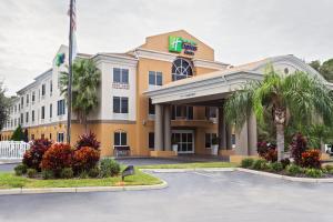 un hotel frente a un edificio con aparcamiento en Holiday Inn Express & Suites Tavares, an IHG Hotel, en Tavares