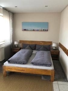 a bedroom with a bed with two pillows on it at Hotel zum Schiffchen in Brüggen