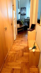 a room with a wooden floor with a laptop on a counter at Turul Apartment Budapest in Budapest