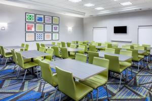 a classroom with tables and chairs and a screen at Holiday Inn Express & Suites Texarkana, an IHG Hotel in Texarkana - Texas