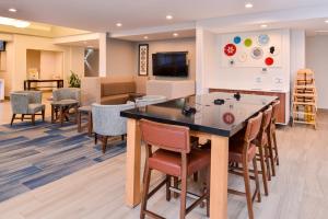 a waiting room at a hospital with a table and chairs at Holiday Inn Express & Suites Lacey - Olympia by IHG in Lacey