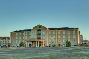 a large building with a large yard in front of it at Holiday Inn Express Hotel & Suites Texarkana East by IHG in Texarkana
