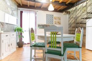 a kitchen with a white table and chairs at Red House- Historic center in Porto +19 photos