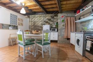 a kitchen with a table and chairs in a room at Red House- Historic center in Porto