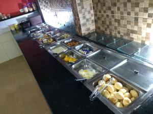a buffet line with many different types of food at Pousada e Restaurante MKE in João Pessoa