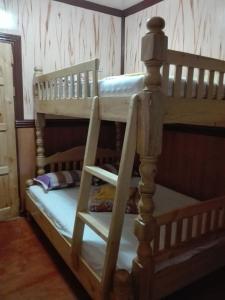 a bunk bed with two bunk beds in a room at Koreen Guest House in Banaue