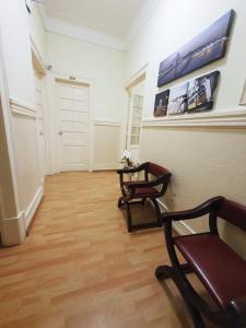 a hallway with two chairs and a table in a room at MIDIS - Alojamento Local in Lisbon