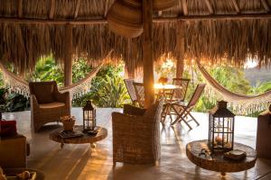 a room with chairs and tables in a resort at Sierra Alta Finca Boutique in Minca