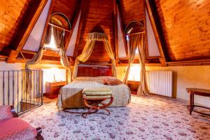 a bedroom with a bed in a room with wooden ceilings at Hotel Belvedere in Sestriere