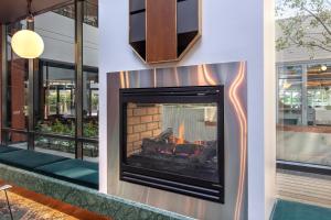 a fireplace in a lobby of a building at Amora Hotel Riverwalk in Melbourne