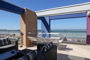 a balcony with chairs and a view of the ocean at Residence La Nave in Senigallia