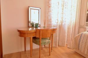 a dressing table with a mirror and a chair at BREZZA MARINA in Rome