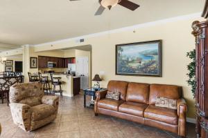 a living room with a leather couch and chairs at TOPS'L Tides III in Destin