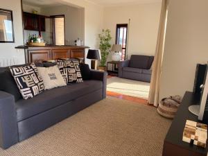 a living room with a blue couch and a table at Beachfront Apartment with Swimming Pool in Mindelo