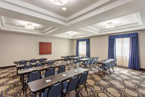 a conference room with tables and chairs and a podium at Holiday Inn Express & Suites Wharton by IHG in Wharton +19 photos