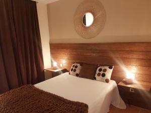 a hotel room with a bed and a mirror at Appartement piscine mer montagne in Les Issambres +11 photos