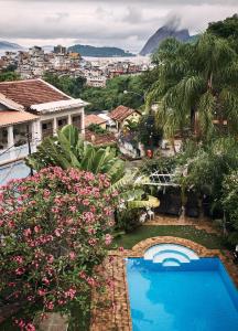 a view of a resort with a swimming pool and flowers at Mama Ruisa Boutique Hotel in Rio de Janeiro