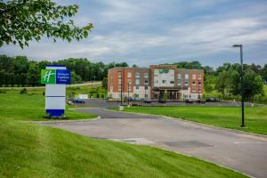 a building on a road with a gas station at Holiday Inn Express & Suites Jamestown, an IHG Hotel in Jamestown